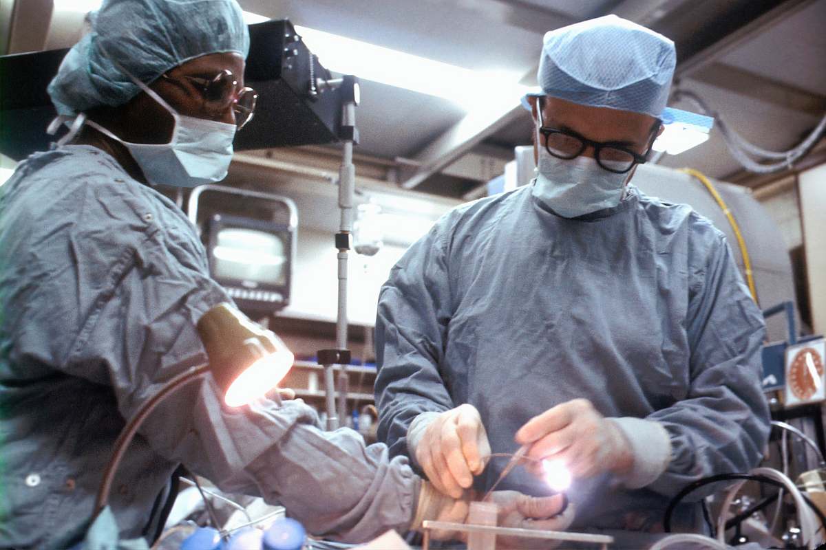 operating theatre man in gray jacket wearing white goggles clinic